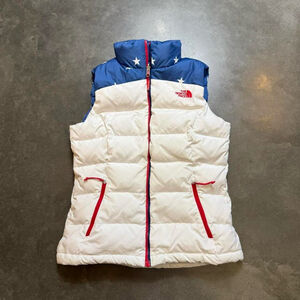 The North Face Women's White Puffy Vest with Blue Star Yoke and Red Accents
